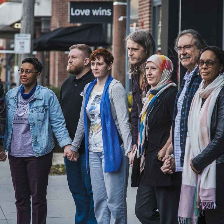 A diverse group of non-traditional families standing together, representing different family structures