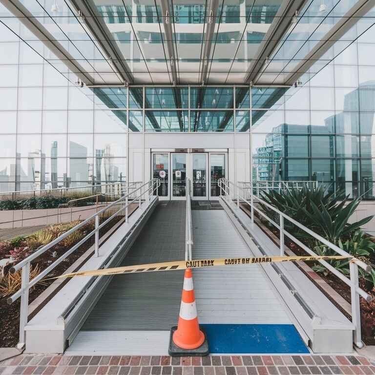 Public building with a blocked wheelchair ramp, representing an ADA compliance mistake