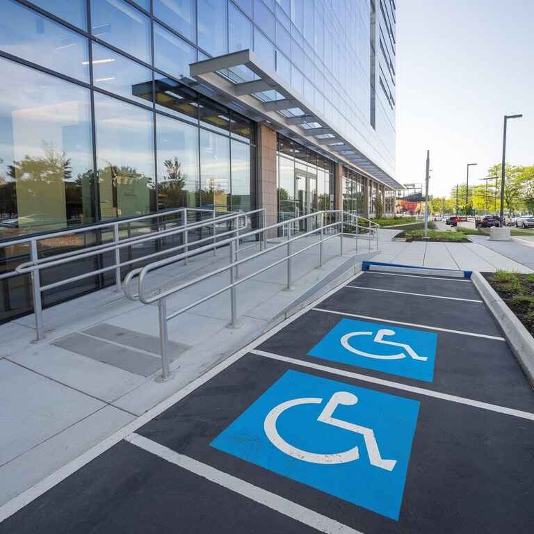 Exterior view of a commercial building with ADA-compliant ramp and parking spaces