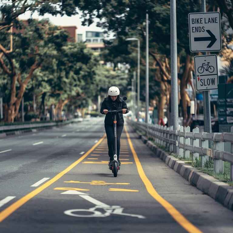 Electric scooter riding in a bike lane with traffic signs in Nevada