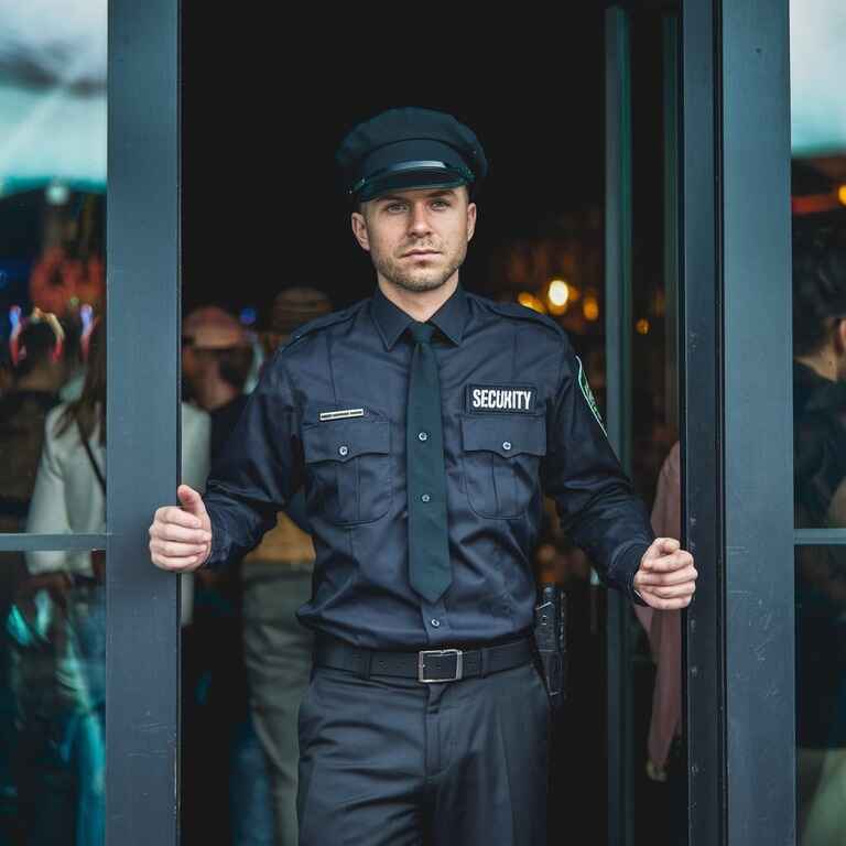 Security guard monitoring nightclub entrance to ensure patron safety