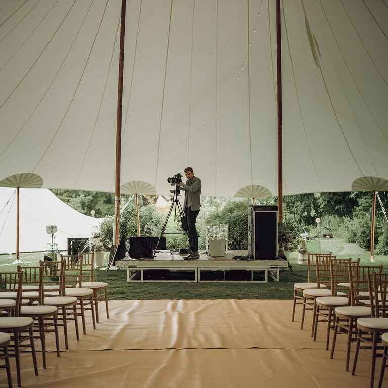 Photographer setting up at an outdoor venue with equipment ready for a shoot