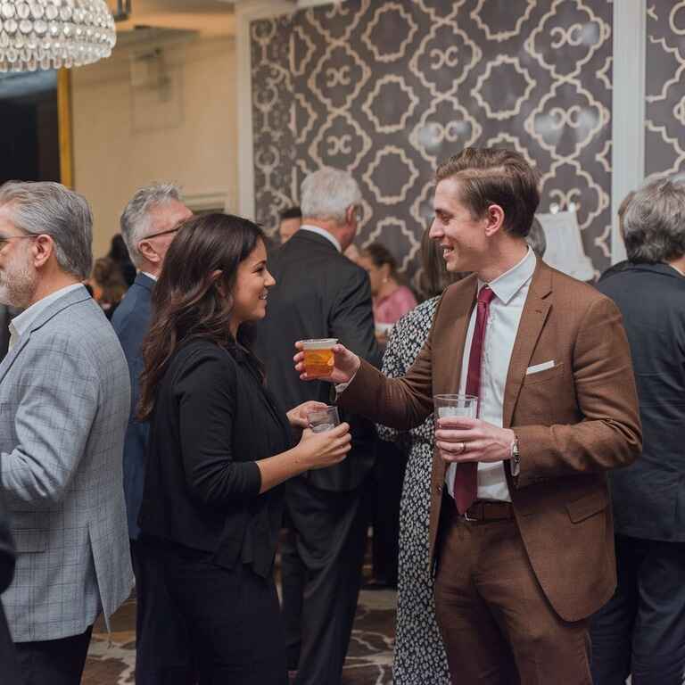 Guests socializing at a party, ensuring drinks are served responsibly