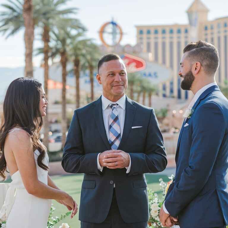 Wedding officiant standing at the altar with a couple, with Las Vegas as the backdrop, symbolizing success in the profession